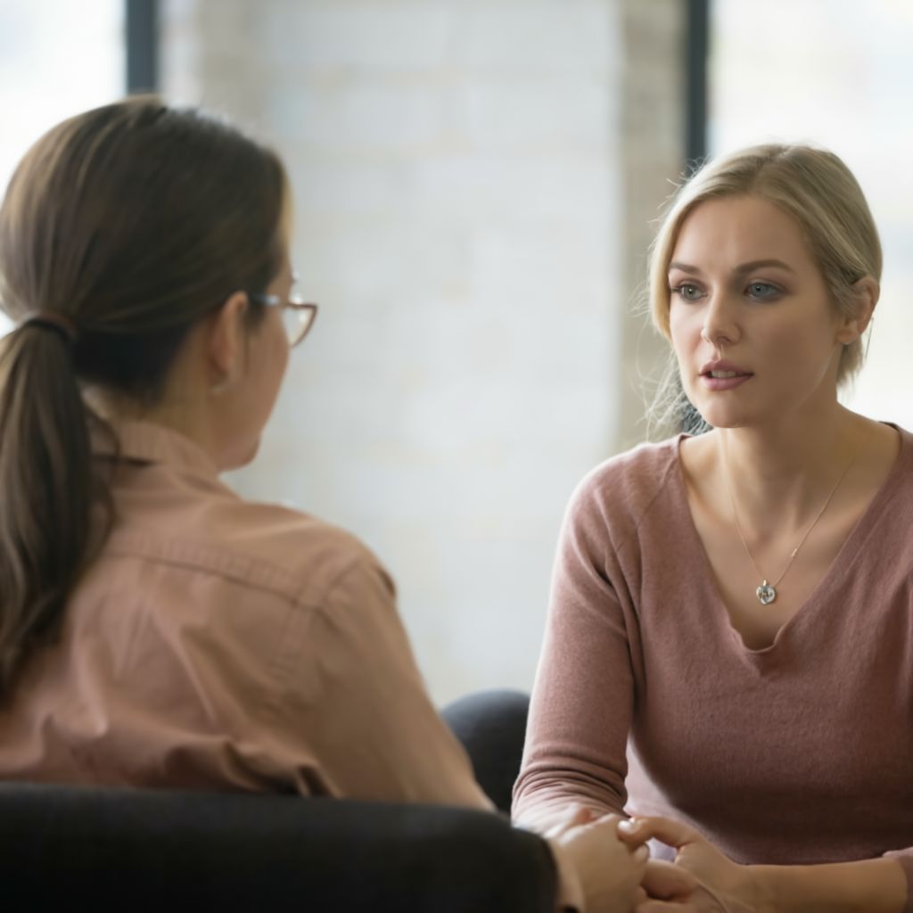 Female counselor seeing a patient in a comfortable office